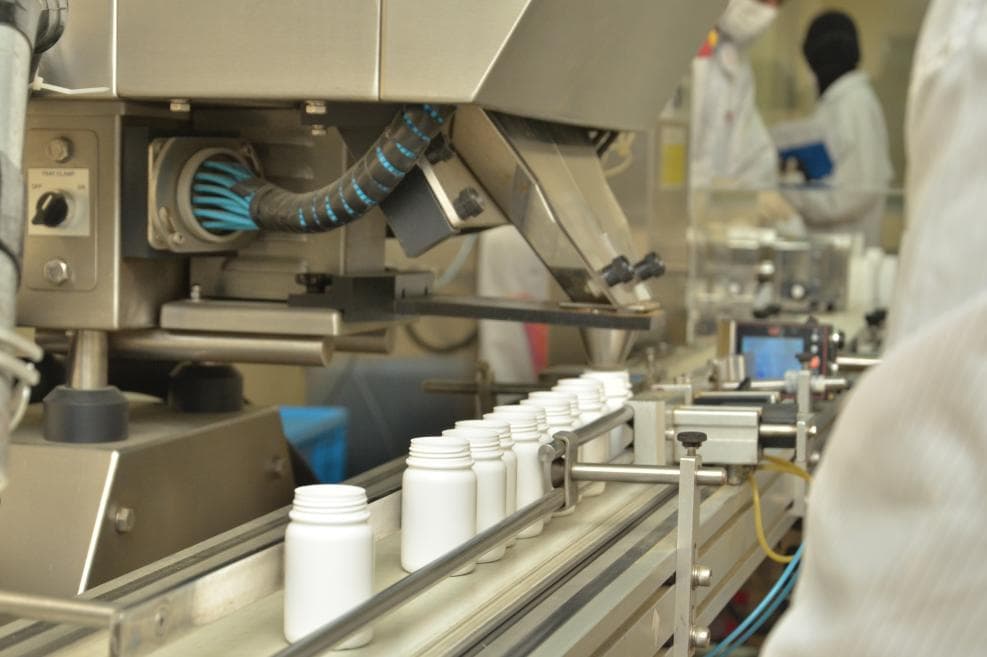 Inserting capsules into bottles