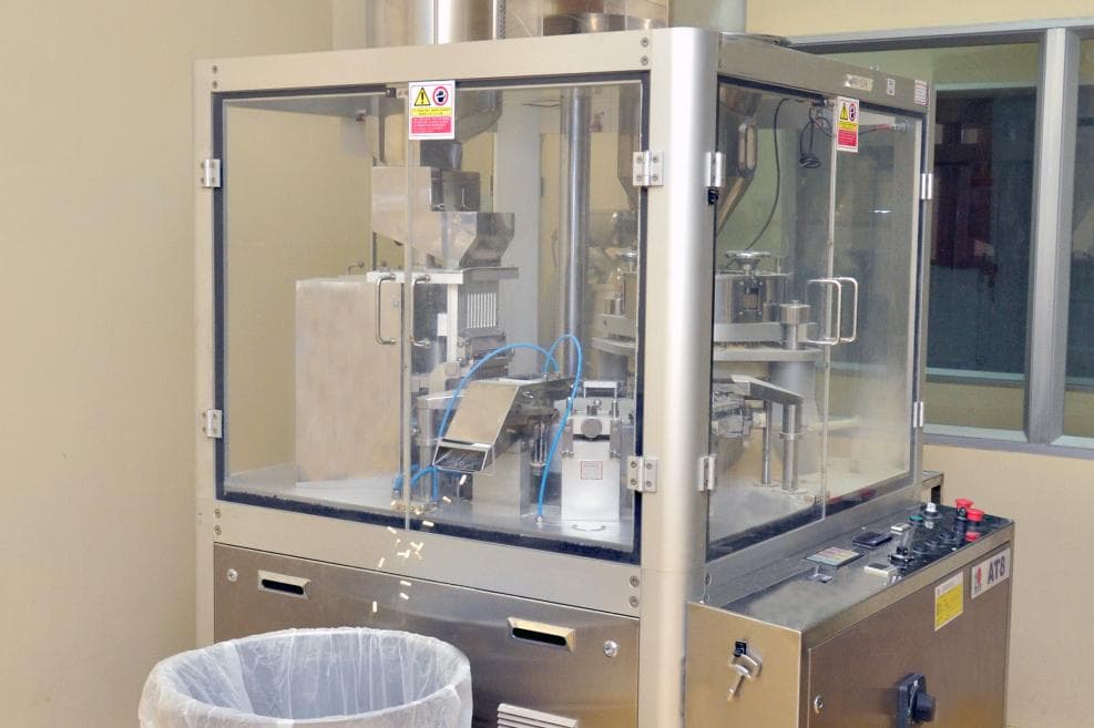 Producing capsules through automatic machinery